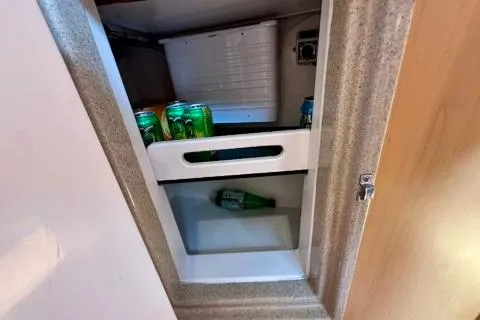 Blue Aweigh Yacht Photos Pics Small refrigerator in a 2021 Tartan 345 yacht with drinks inside.