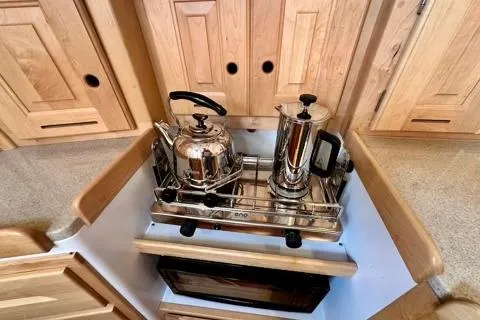 Blue Aweigh Yacht Photos Pics Stainless steel kettle and coffee maker on Tartan 345 yacht's wooden kitchen counter, 2021 model.