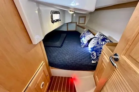 Blue Aweigh Yacht Photos Pics 2021 Tartan 345 yacht cabin with cozy bedding and modern wood finish.