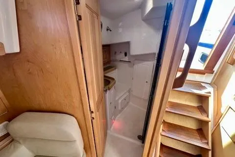 Blue Aweigh Yacht Photos Pics Interior of 2021 Tartan 345 yacht, featuring wooden cabinetry and compact kitchen area.