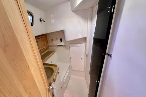 Blue Aweigh Yacht Photos Pics 2021 Tartan 345 yacht bathroom with compact design and wooden cabinetry.