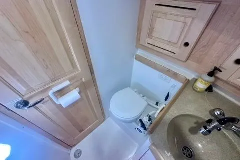 Blue Aweigh Yacht Photos Pics Compact bathroom in 2021 Tartan 345 yacht with wooden cabinetry and modern fixtures.