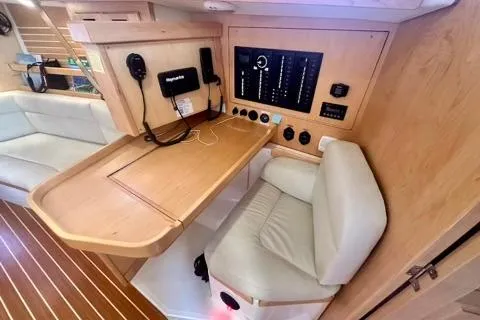 Blue Aweigh Yacht Photos Pics 2021 Tartan 345 yacht interior with navigation station and control panel.