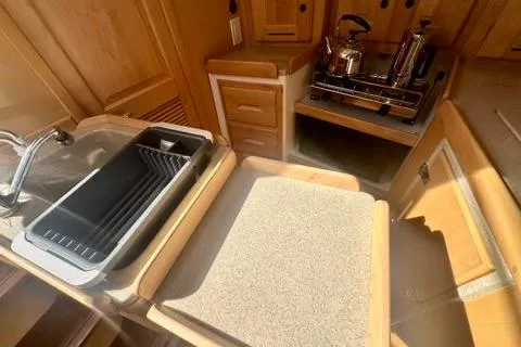 Blue Aweigh Yacht Photos Pics Compact kitchen area in 2021 Tartan 345 yacht with sink and stove.