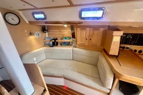 Blue Aweigh Yacht Photos Pics Interior of 2021 Tartan 345 sailboat with cozy seating and wooden cabinetry.
