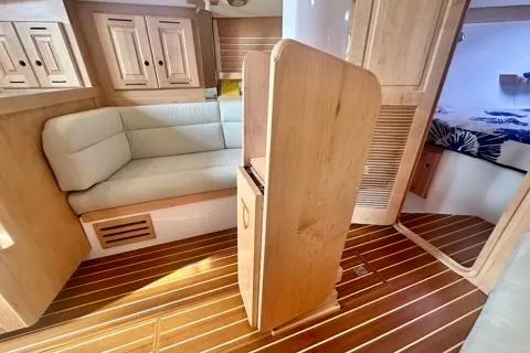 Blue Aweigh Yacht Photos Pics 2021 Tartan 345 yacht interior with wooden finish and cozy seating area.