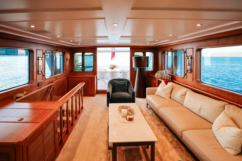Kapal Yacht Photos Pics Luxurious 1971 Feadship yacht interior with elegant wood paneling and ocean view.
