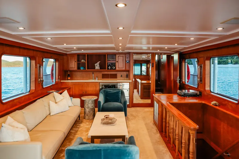 Kapal Yacht Photos Pics Luxurious 1971 Feadship yacht interior with elegant wood finishes and comfortable seating.