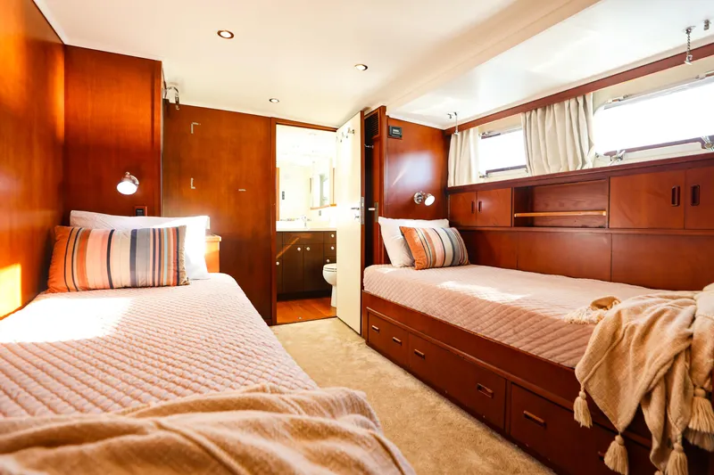 Kapal Yacht Photos Pics Luxurious 1971 Feadship yacht cabin with twin beds, wooden interior, and natural light.