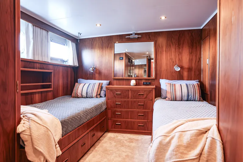 Kapal Yacht Photos Pics Luxurious 1971 Feadship yacht cabin with twin beds, wood paneling, and elegant decor.