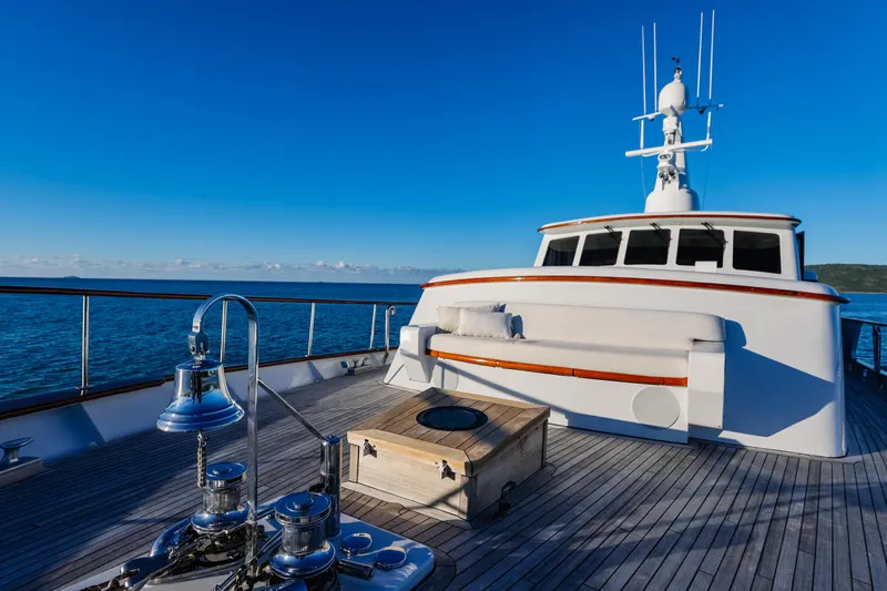 Kapal Yacht Photos Pics Vintage 1971 Feadship yacht deck with ocean view, featuring polished wood and nautical equipment.