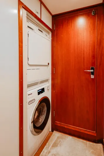 Kapal Yacht Photos Pics Laundry area with Miele washer in 1971 Feadship yacht interior.