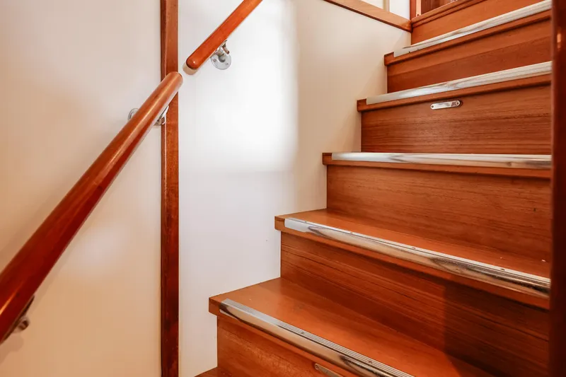 Kapal Yacht Photos Pics Wooden staircase with metal accents on a 1971 Feadship yacht.