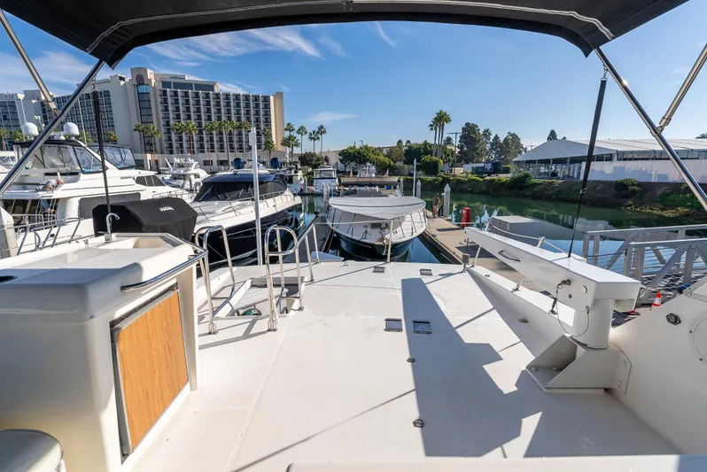 Hyve Yacht Photos Pics 2001 Bayliner 4788 Pilothouse yacht docked at marina with scenic waterfront view.