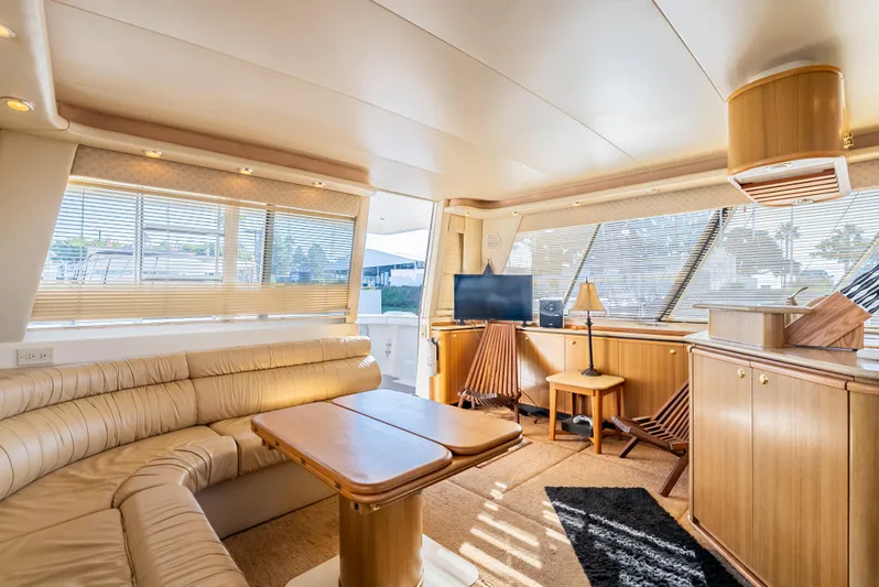 Hyve Yacht Photos Pics Luxurious interior of 2001 Bayliner 4788 Pilothouse yacht with elegant seating and wooden accents.