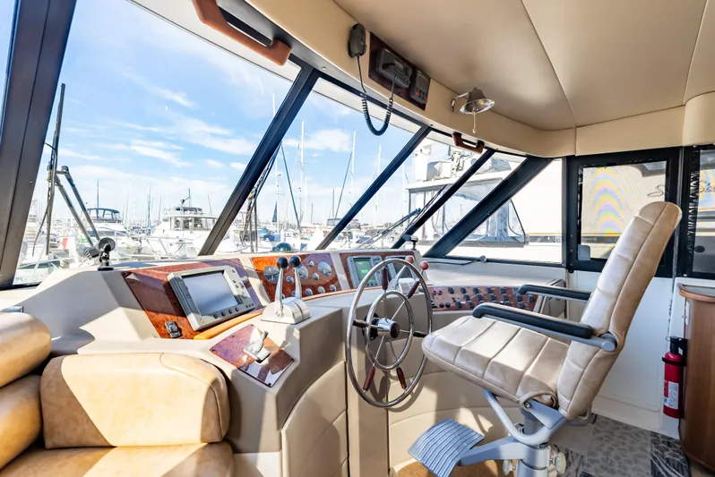 Hyve Yacht Photos Pics 2001 Bayliner 4788 Pilothouse interior with helm, steering wheel, and navigation equipment.