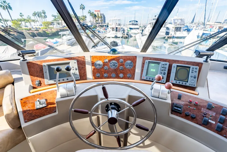 Hyve Yacht Photos Pics 2001 Bayliner 4788 Pilothouse helm with navigation instruments and marina view.