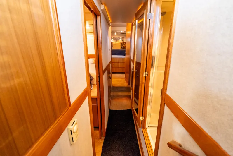 Hyve Yacht Photos Pics Interior hallway of 2001 Bayliner 4788 Pilothouse yacht with wooden accents.