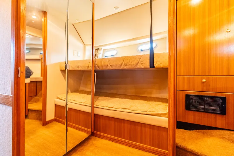 Hyve Yacht Photos Pics Interior of 2001 Bayliner 4788 Pilothouse with cozy bunk beds and wooden cabinetry.