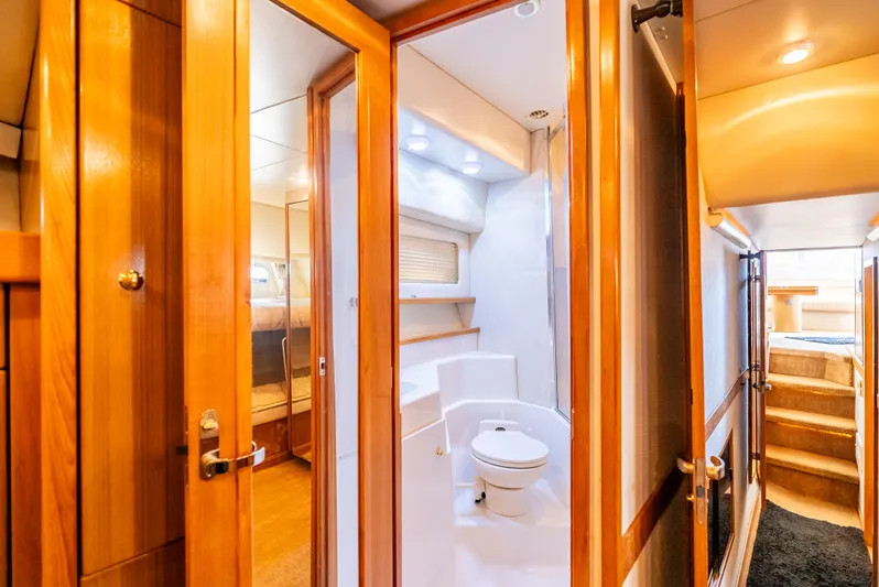 Hyve Yacht Photos Pics Interior of 2001 Bayliner 4788 Pilothouse yacht, featuring a bathroom and wooden finishes.
