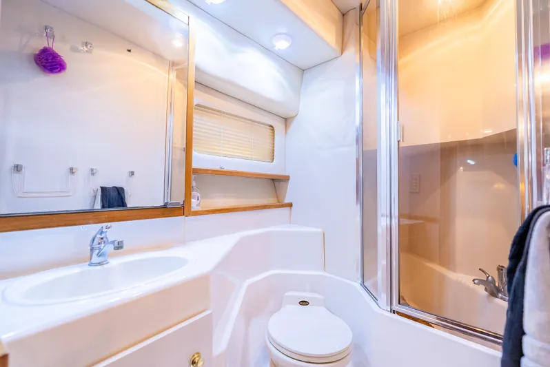 Hyve Yacht Photos Pics Luxurious bathroom in 2001 Bayliner 4788 Pilothouse yacht with modern fixtures and shower.