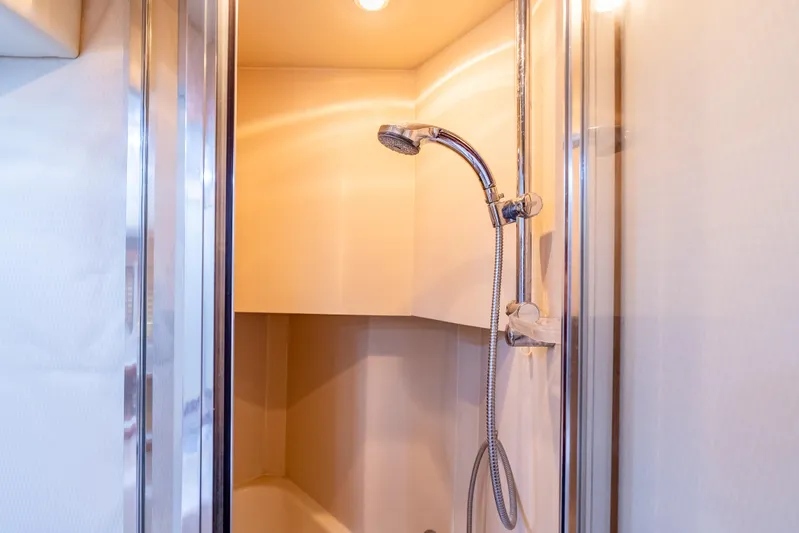 Hyve Yacht Photos Pics Shower area in 2001 Bayliner 4788 Pilothouse yacht, featuring modern fixtures and lighting.