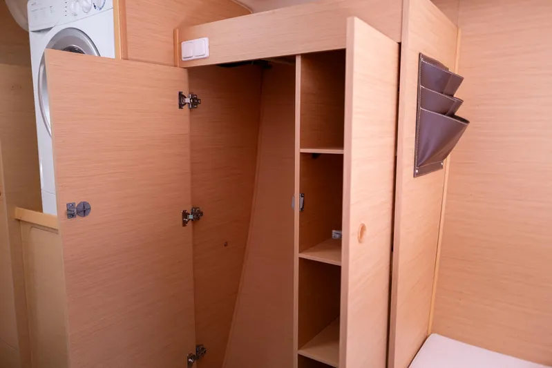 Dream Seeker Yacht Photos Pics Interior of 2011 Lagoon 380 S2 yacht with open wooden cabinets and washing machine.