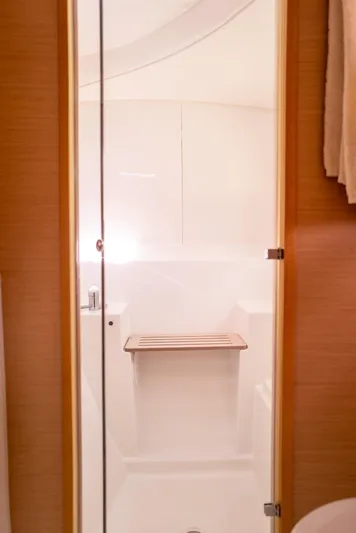 Dream Seeker Yacht Photos Pics Interior of 2011 Lagoon 380 S2 yacht bathroom with wooden seat and glass door.