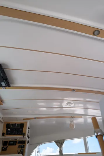 Dream Seeker Yacht Photos Pics Interior ceiling of 2011 Lagoon 380 S2 catamaran with wood accents and control panels.