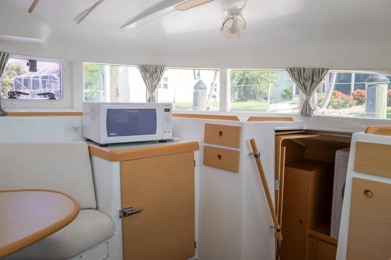Dream Seeker Yacht Photos Pics Interior of 2011 Lagoon 380 S2 yacht with microwave and wooden cabinetry.