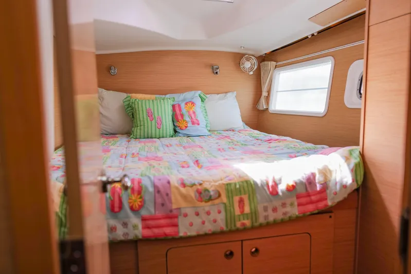 Dream Seeker Yacht Photos Pics Cozy bedroom in 2011 Lagoon 380 S2 catamaran with colorful bedding and natural light.