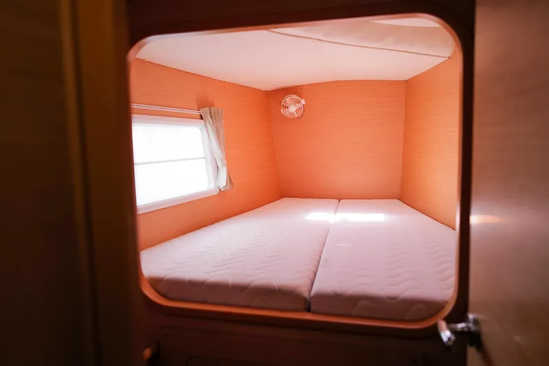 Dream Seeker Yacht Photos Pics Cozy cabin interior of 2011 Lagoon 380 S2 catamaran with double bed and window.