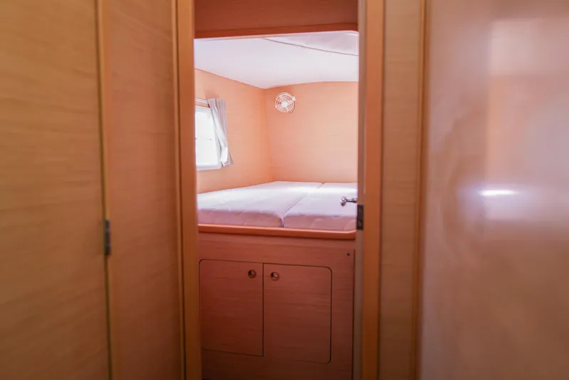 Dream Seeker Yacht Photos Pics Cozy cabin interior of 2011 Lagoon 380 S2 catamaran with wooden finish and bed.
