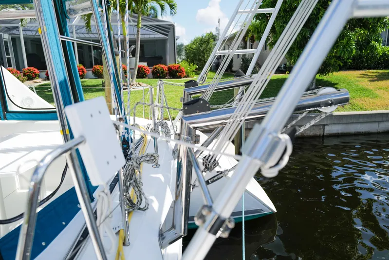 Dream Seeker Yacht Photos Pics Lagoon 380 S2 catamaran docked, showcasing rigging and lush garden backdrop.