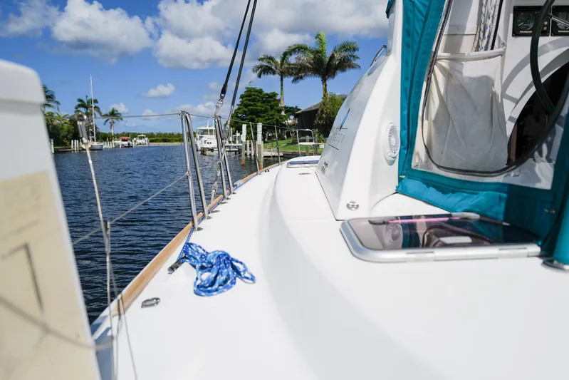 Dream Seeker Yacht Photos Pics Lagoon 380 S2 sailboat on a sunny day, docked by a tropical waterfront.