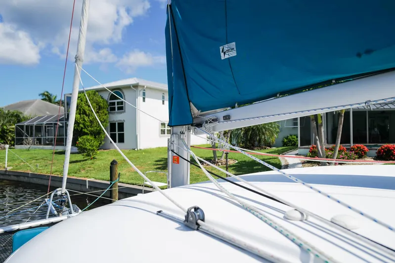 Dream Seeker Yacht Photos Pics Sailboat Lagoon 380 S2, 2011 model, docked near waterfront homes, blue sky background.