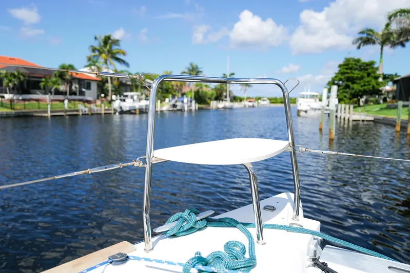 Dream Seeker Yacht Photos Pics Bow of 2011 Lagoon 380 S2 catamaran on a sunny day, docked in a scenic canal.
