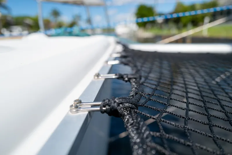 Dream Seeker Yacht Photos Pics Close-up of netting on a 2011 Lagoon 380 S2 catamaran, with blurred background.