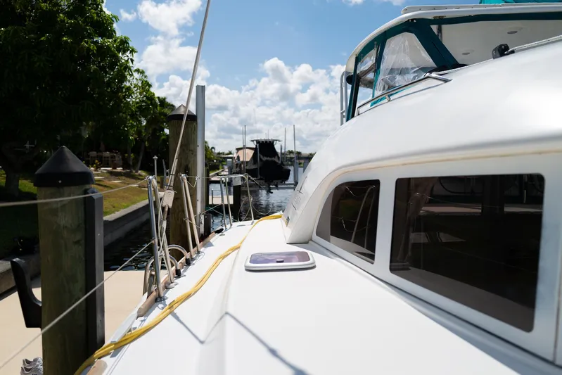Dream Seeker Yacht Photos Pics 2011 Lagoon 380 S2 catamaran docked in a sunny marina.