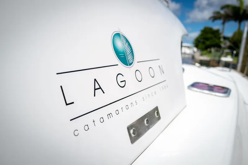 Dream Seeker Yacht Photos Pics Lagoon 380 S2 catamaran logo on white surface, 2011 model, sunny day background.