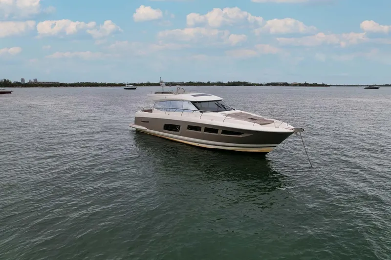  Yacht Photos Pics 2015 Prestige 550 S yacht on calm water under a partly cloudy sky.