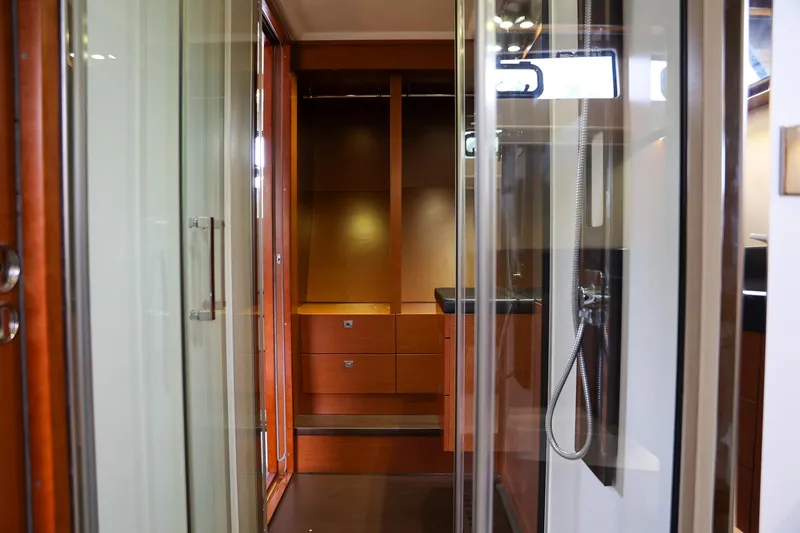  Yacht Photos Pics Interior of 2015 Prestige 550 S yacht with wooden cabinetry and glass shower.