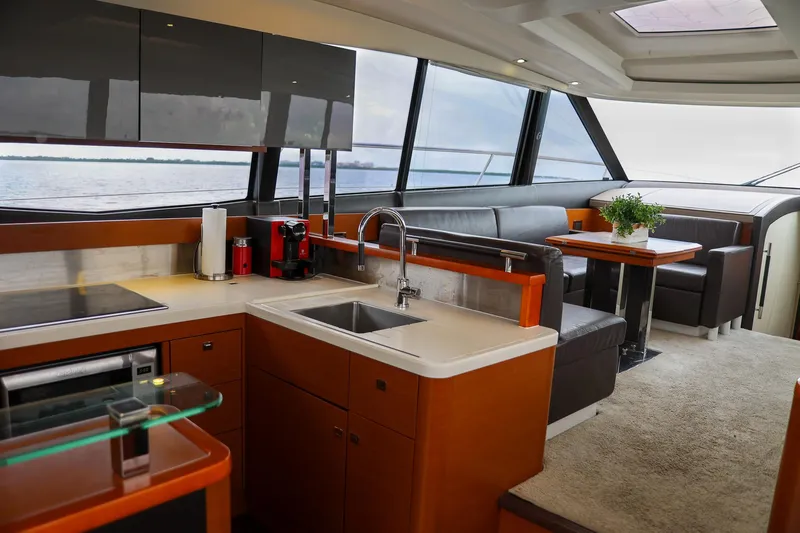  Yacht Photos Pics Luxurious interior of 2015 Prestige 550 S yacht with modern kitchen and seating area.
