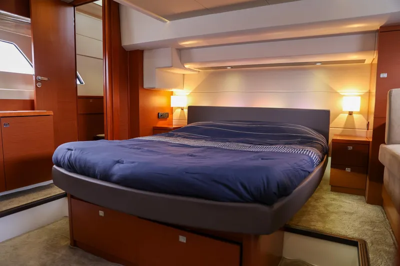  Yacht Photos Pics Luxurious bedroom interior of 2015 Prestige 550 S yacht with cozy lighting.