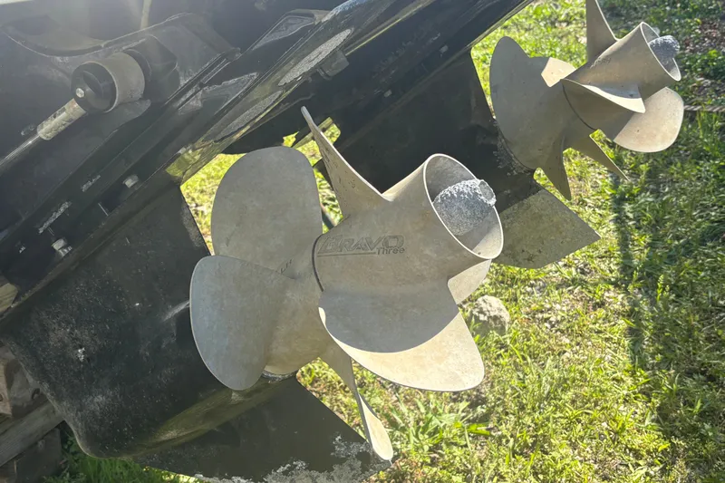  Yacht Photos Pics Propellers of a 2021 Monterey 298 Super Sport boat on grassy ground.