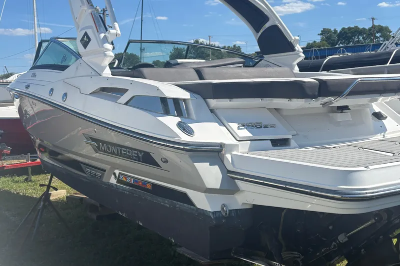  Yacht Photos Pics 2021 Monterey 298 Super Sport boat with sleek design, docked outdoors under blue sky.
