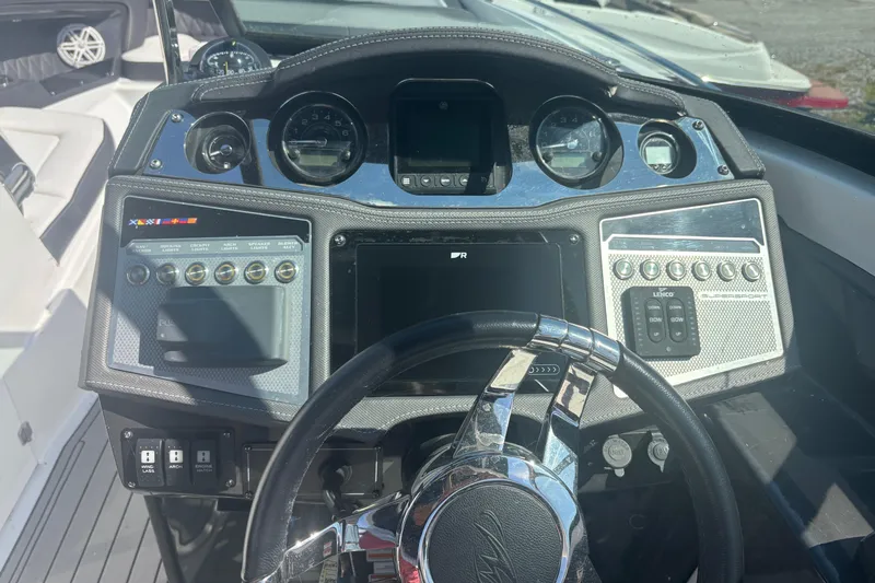  Yacht Photos Pics Dashboard of a 2021 Monterey 298 Super Sport boat with steering wheel and controls.