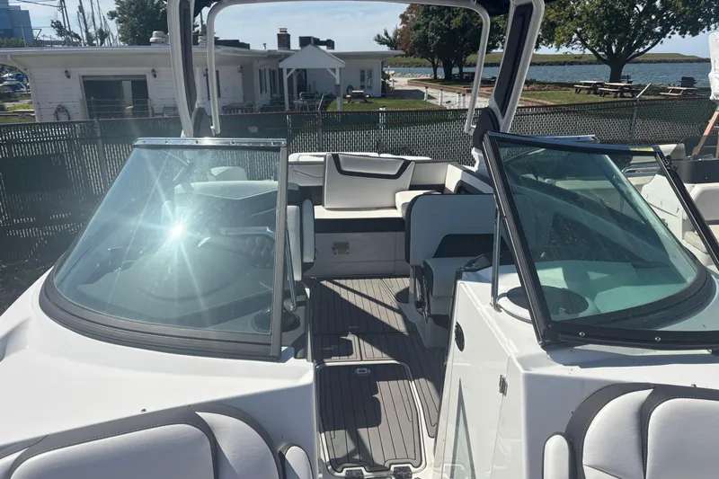  Yacht Photos Pics 2021 Monterey 298 Super Sport boat interior with seating and windshield, docked near waterfront.