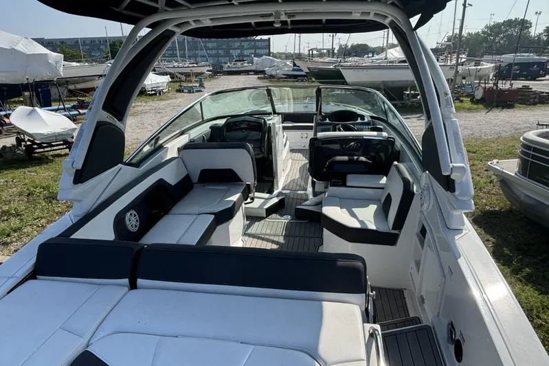  Yacht Photos Pics 2021 Monterey 298 Super Sport boat interior with seating and helm, docked outdoors.