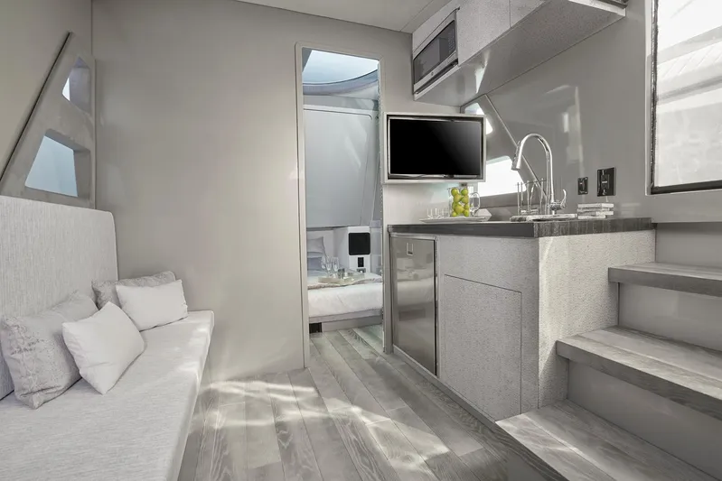  Yacht Photos Pics Modern interior of 2019 Midnight Express 60' Pied-A-Mer yacht with kitchenette and seating area.